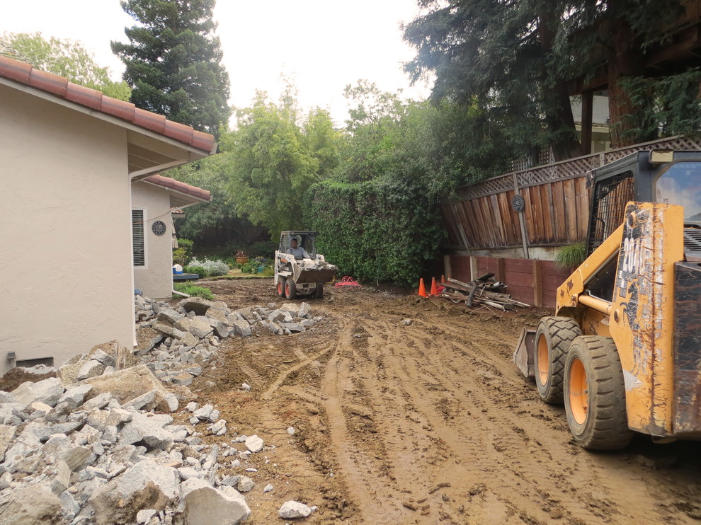 Bobcat removing dirt and concrete debris from Bay Area property